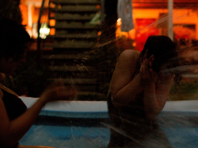 Series: water — splash covering a face in a night pool