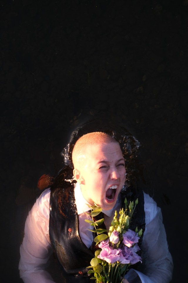 Series: water — scream emerging from dark water with flowers